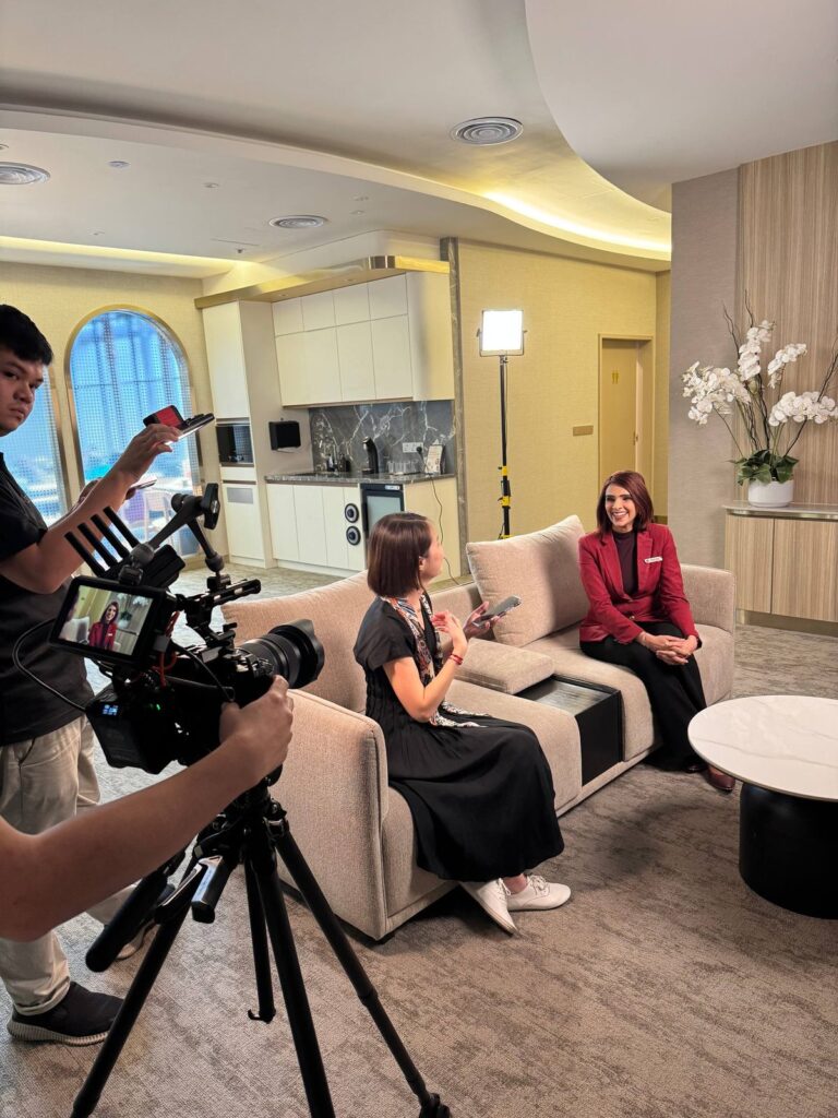 A closer view of the Premium Lounge scene, with a camera operator in the foreground