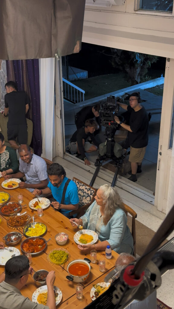 Family dinner scene with the camera on a dolly outside the open doors